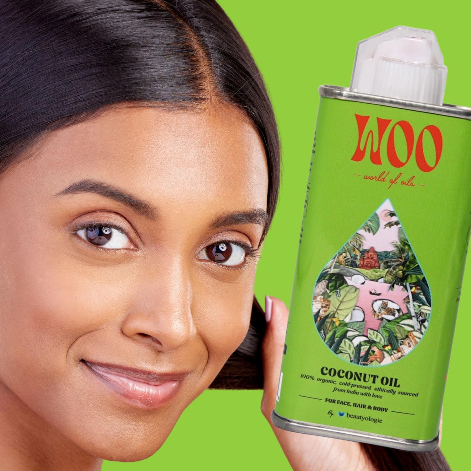 Woman holding Woo coconut oil can against green background