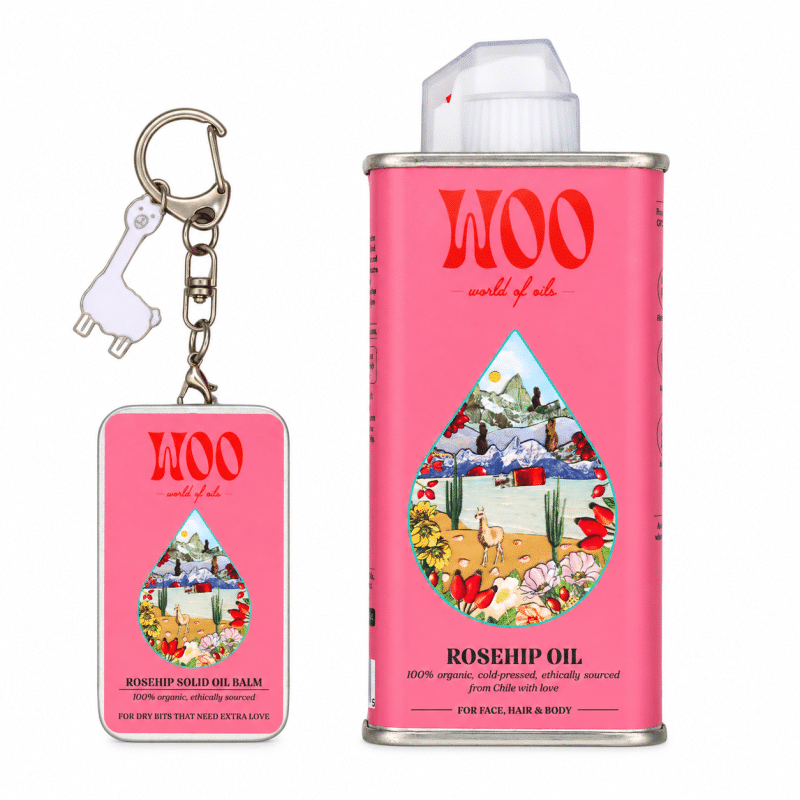 Pink rosehip oil can beside matching balm keychain