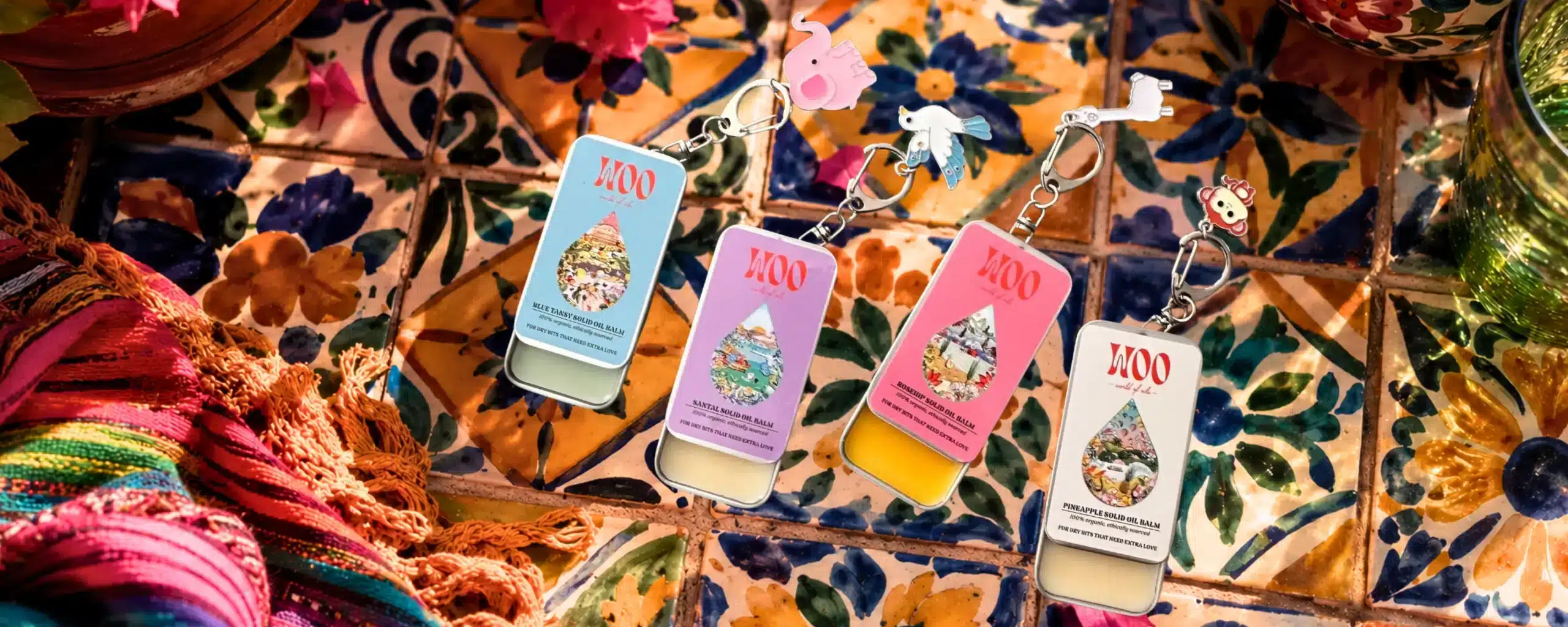 Four colorful MOO solid oil balm keychains