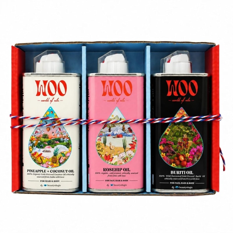 Three WOO body oil spray cans in gift box