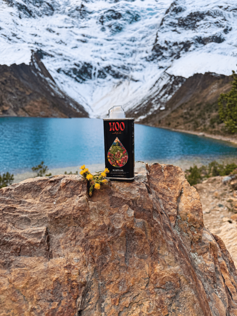 Buriti oil bottle on rock above turquoise glacial lake